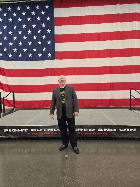 Case Manager presenting Human Trafficking 101 standing in front of US Flag